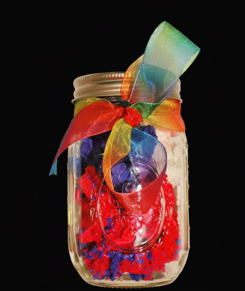 Decorative jar with colorful ribbons and beads on a black background