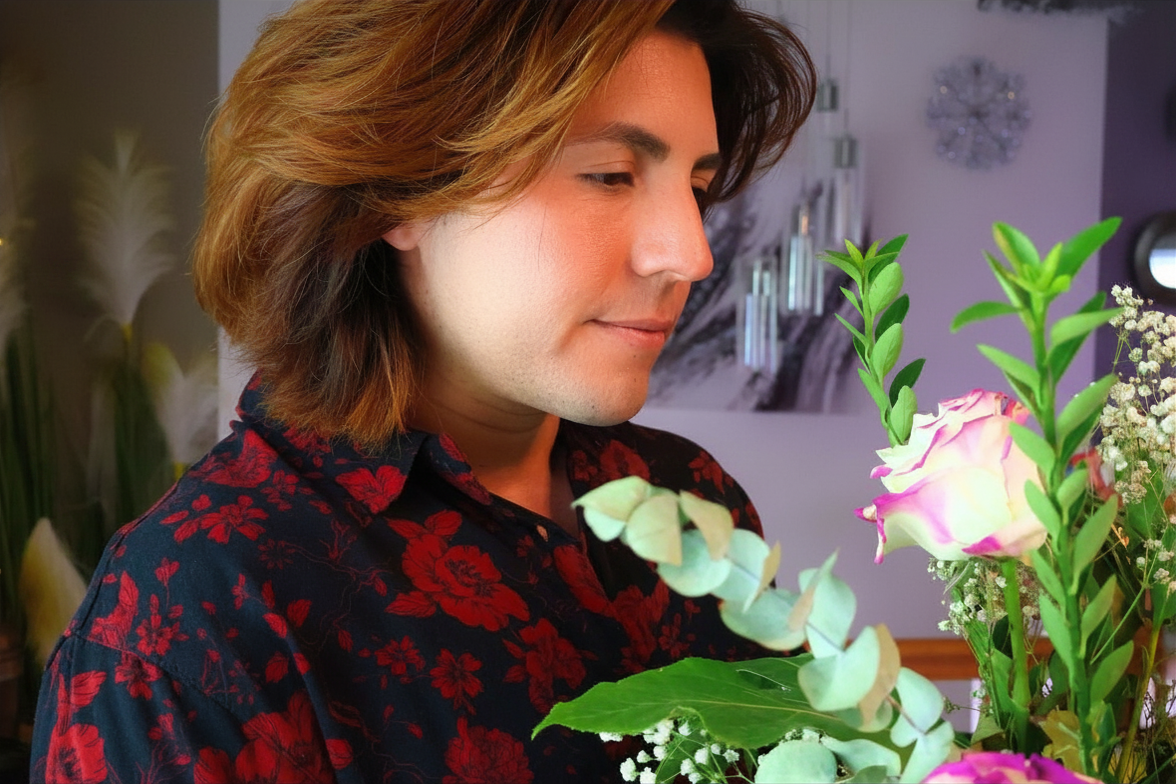 Person holding a bouquet of flowers indoors