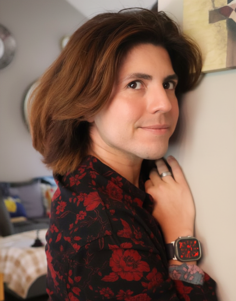 Woman wearing a black and red floral jacket in an indoor setting